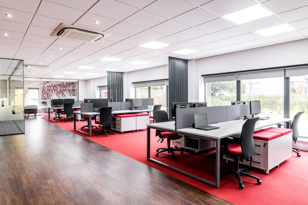 APS showroom open plan office area with bench desks, suspended ceilings and flooring finishes.
